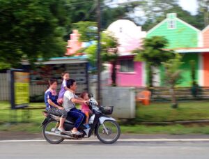 A family of 4 persons on a Honda scooter in Chiang Mai