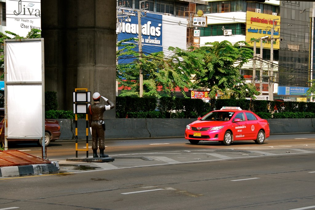 A dummy policeman and a cab in the Pinklao area, Bangkok.