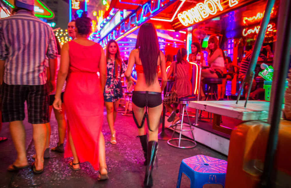 Bar girl walking on Soi Cowboy, Bangkok