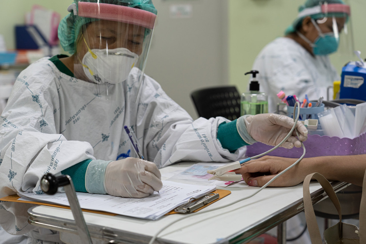 Two healthcare workers at Bamrasnaradura Infectious Disease Institute in Nonthaburi.