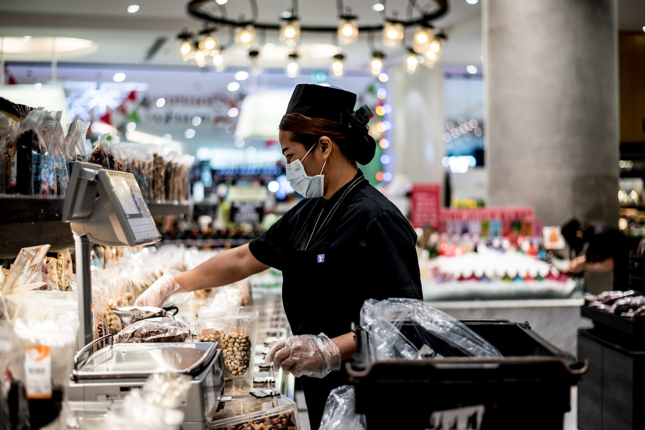 Supermarket cashier in Bangkok during the COVID-19 pandemic