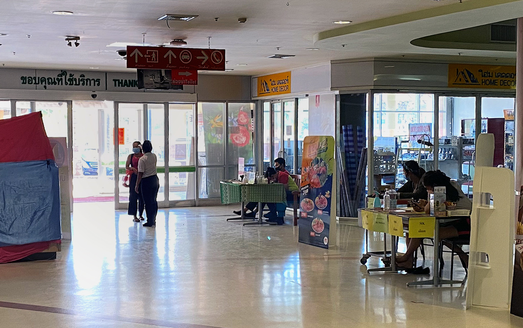 COVID-19 temperature checking point at shopping mall entrance in Thailand