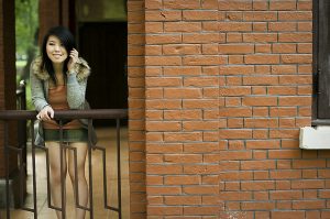 Beautiful Chinese girl posing on a railing