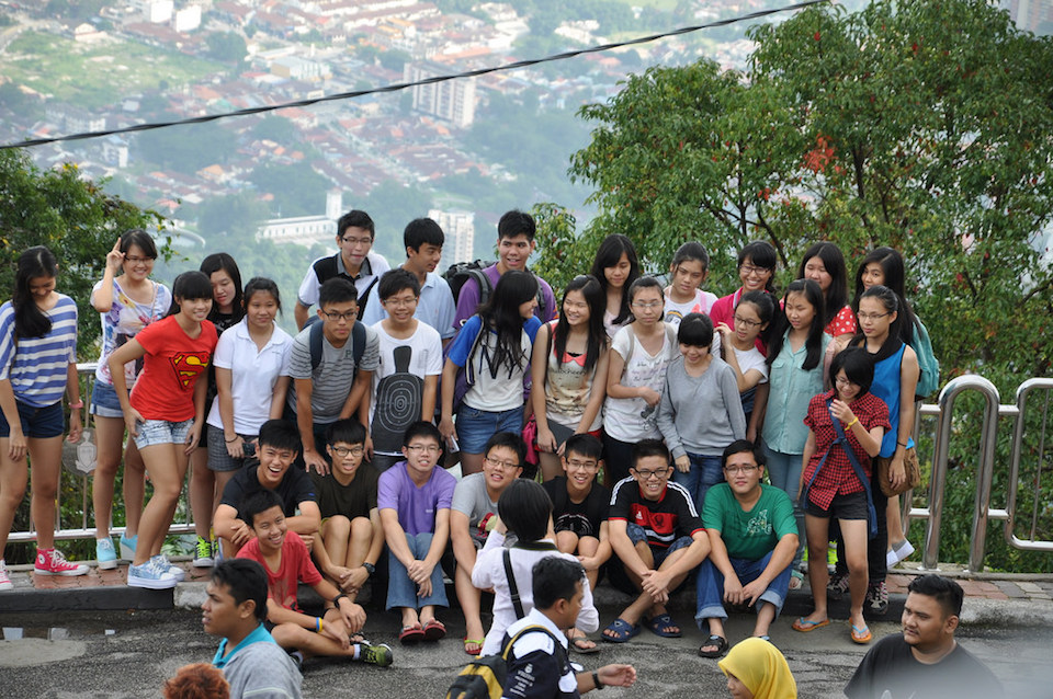Chinese tourists pose for a photograph