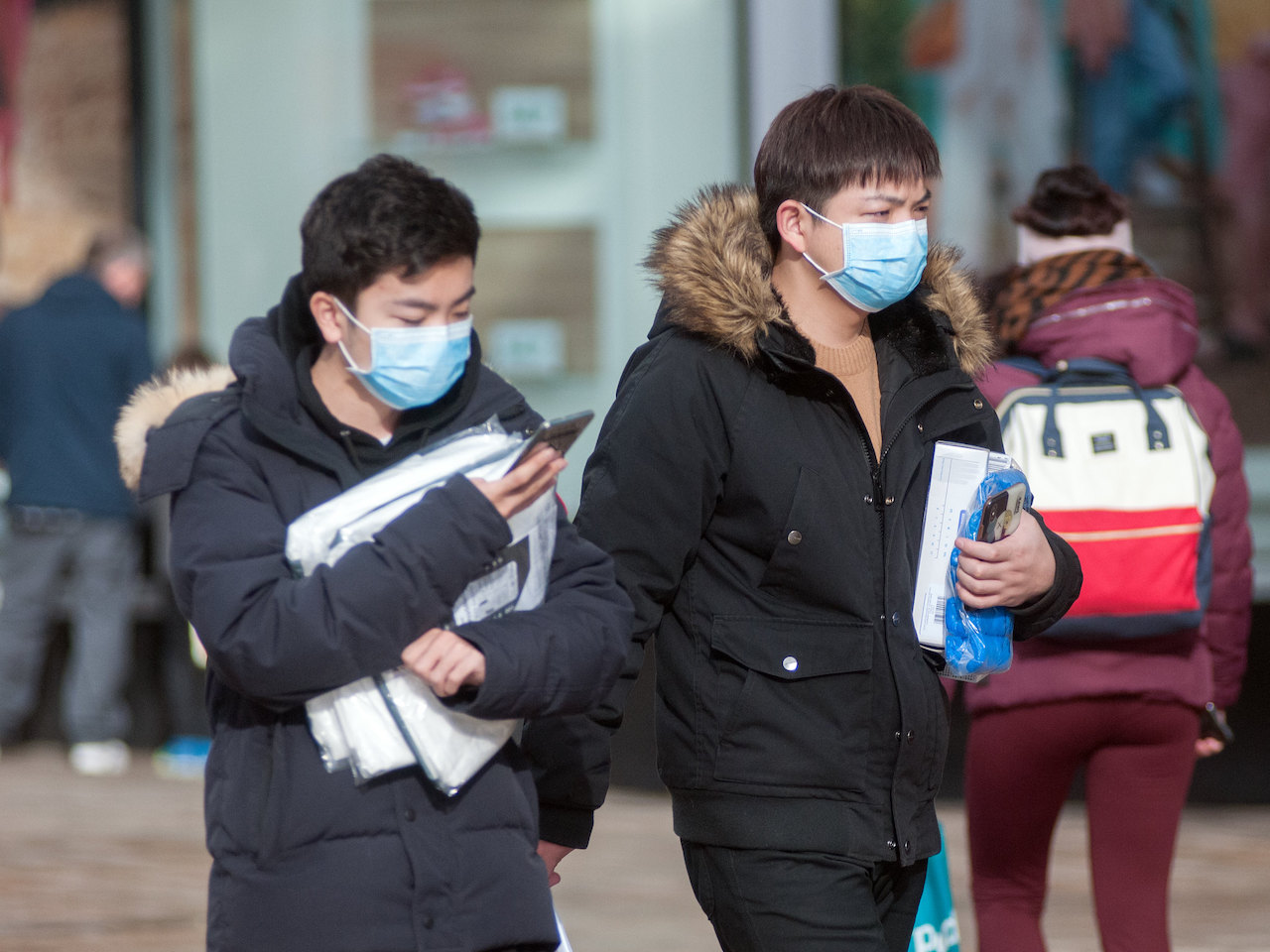 People wearing masks due COVID surge in China