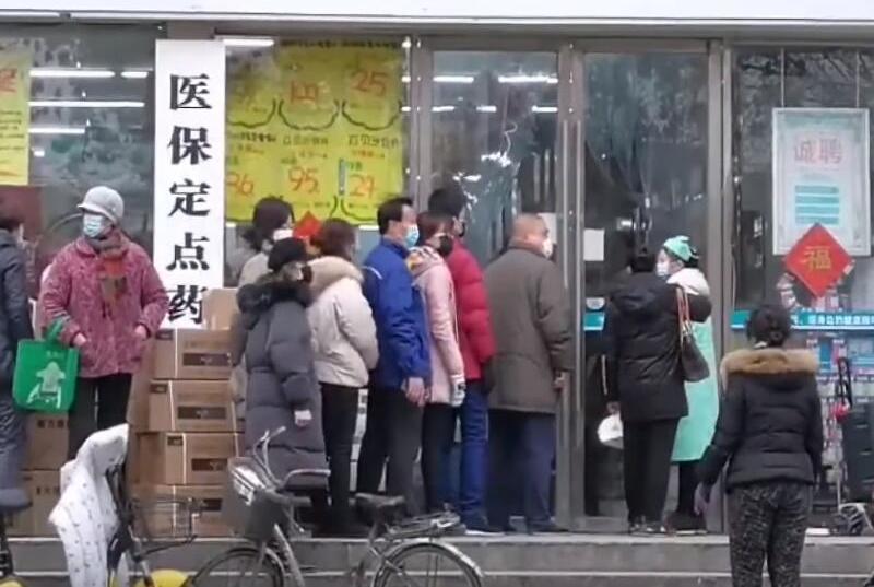 People lining up outside of a drug store to buy masks during the Wuhan coronavirus outbreak in Wuhan, China