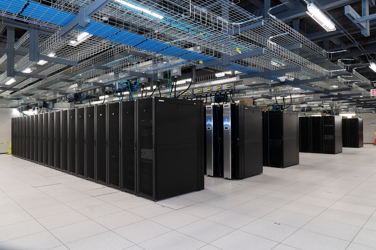 A data center with rows of black computer servers.