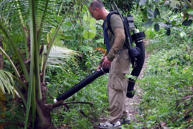 Entomologist using a large powered aspirator to collect mosquitoes in northern Thailand