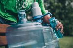 Filling bottle with water.