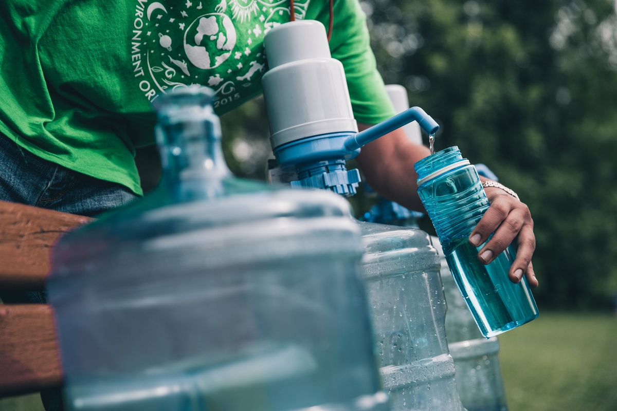 Filling bottle with water.