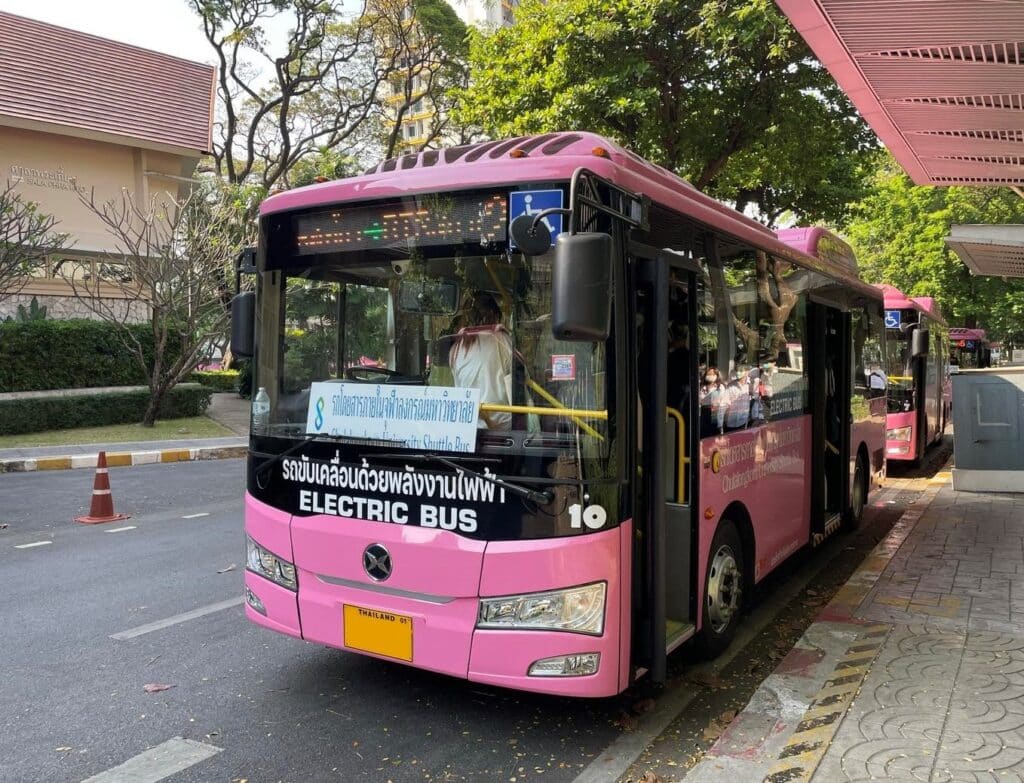 Pink electric bus at Chulalongkorn University campus.