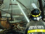 Thai firefighter spraying water