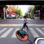 Girls wearing masks on a crosswalk in Bangkok during the COVID-19 pandemic