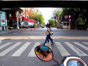 Girls wearing masks on a crosswalk in Bangkok during the COVID-19 pandemic