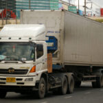 Hino truck draws a refrigerated container past Secon Square in Bangkok.