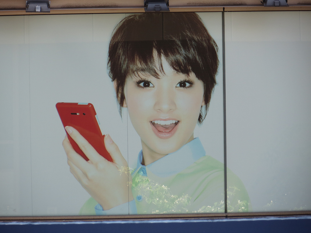 Japanese actress and model Ayame Gorki holding a mobile phone