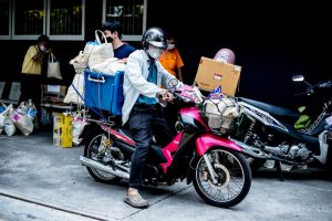 A man rides a motorbike in Bangkok during the COVID-19 pandemic