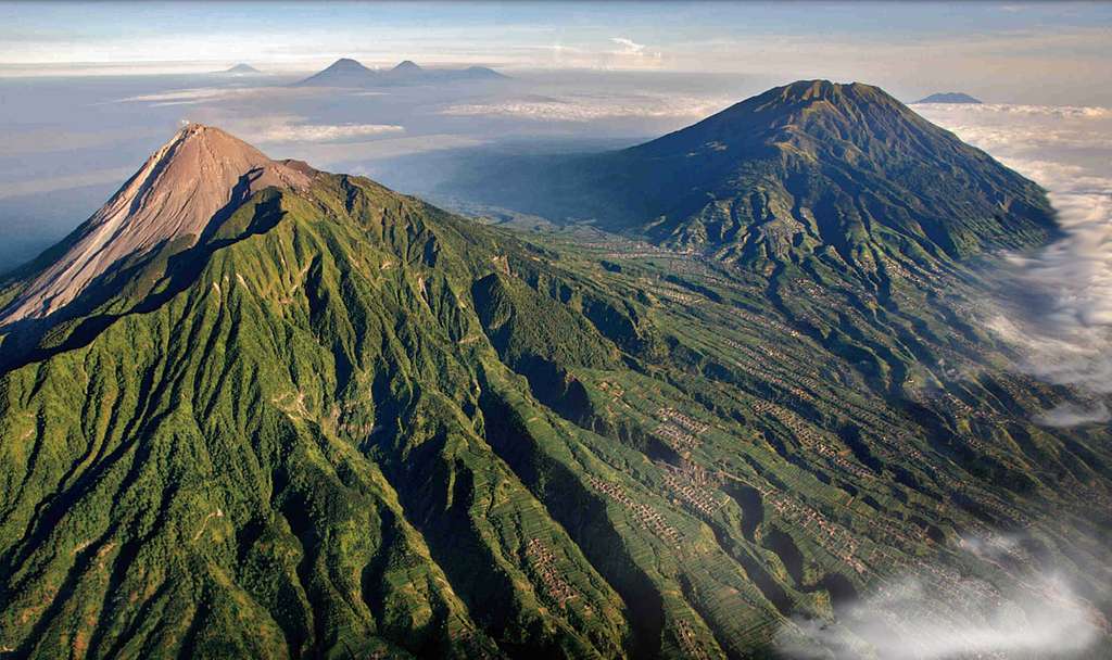 Aerial view of Mount Merapi volcano and six other volcanoes (Mount Merbabu, Mount Ungaran, Mount Sumbing, Mount Sundoro, Dieng and Mount Slamet) on the island of Java, Indonesia.