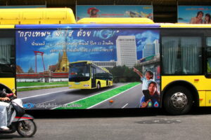 A sign extolling the virtues of Natural Gas propulsion (NGV) on the side of a bus on BMTA line in Bangkok