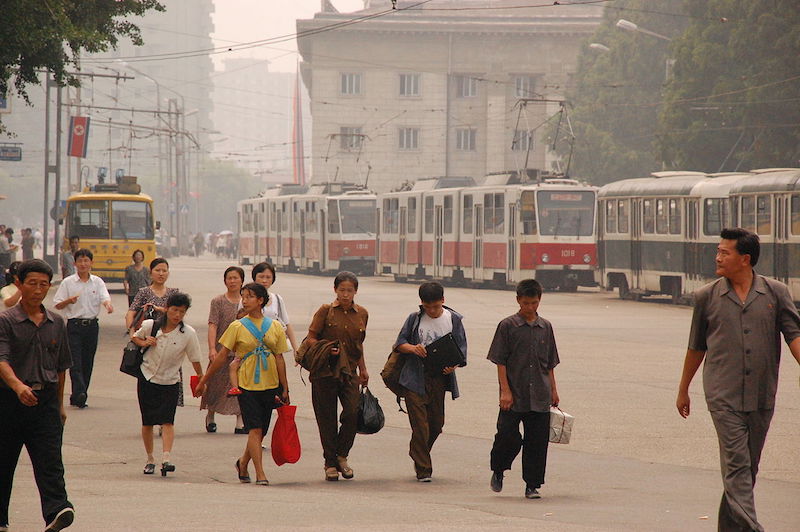 People walking on sidewalk in central Pyongyang