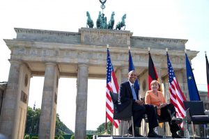Hussein Obama and Merkel at the Brandenburg Gate in 2013