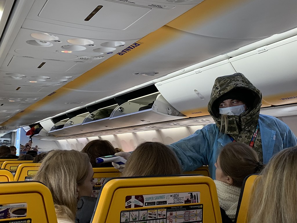 Staff monitoring passengers' body temperature on board of the plane in Boryspil International Airport, Kiev, Ukraine, during 2019–20 coronavirus outbreak