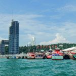 Pattaya City sign and boats at Pattaya pier