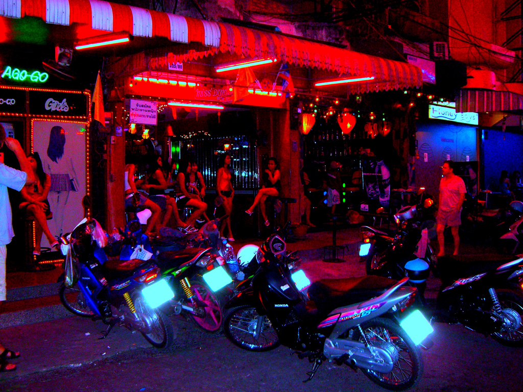 Girls at Walking Street in front parked motorbikes.