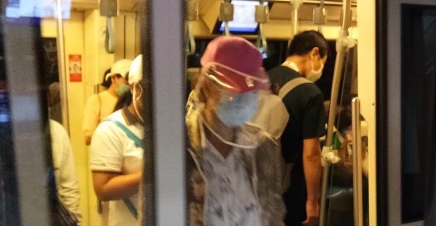 People wearing masks on MRT train in Bangkok during COVID-19 pandemic