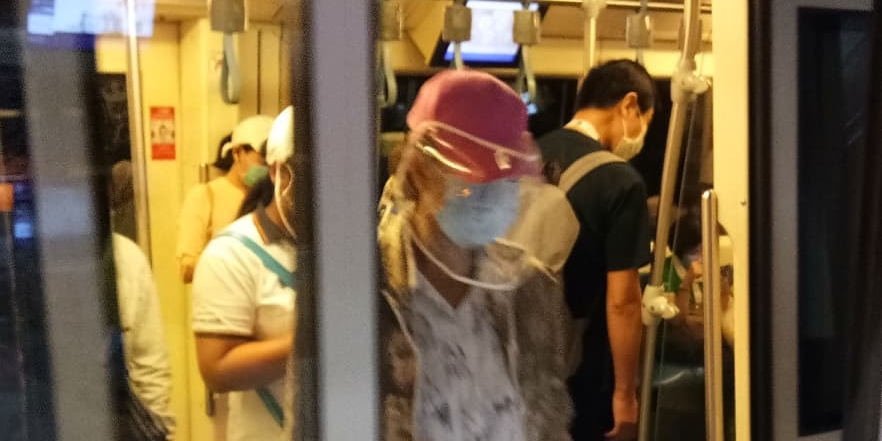 People wearing masks on MRT train in Bangkok during COVID-19 pandemic