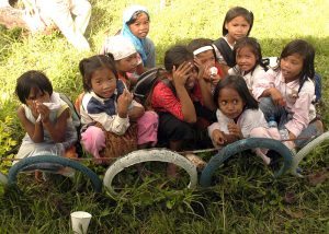 Filipino girls sit outside Paaralang Elementary School during a medical civil assistance program (MEDCAP).