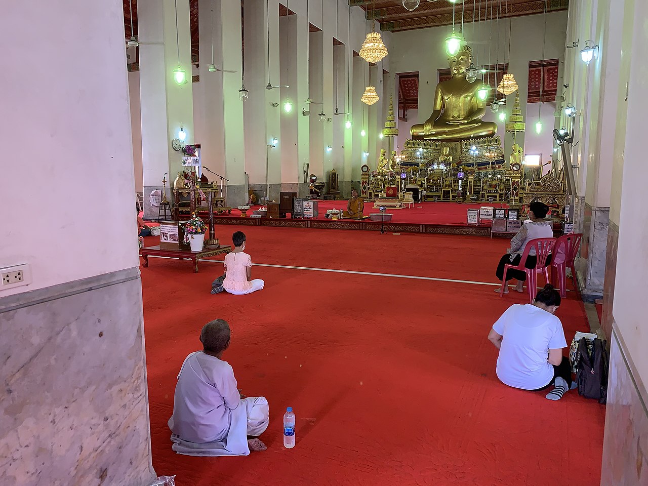 Buddhists keeping physical distance during COVID-19 at Wat Mahathat Yuwarat Rangsarit, Bangkok on the Buddhist Atthami Bucha day