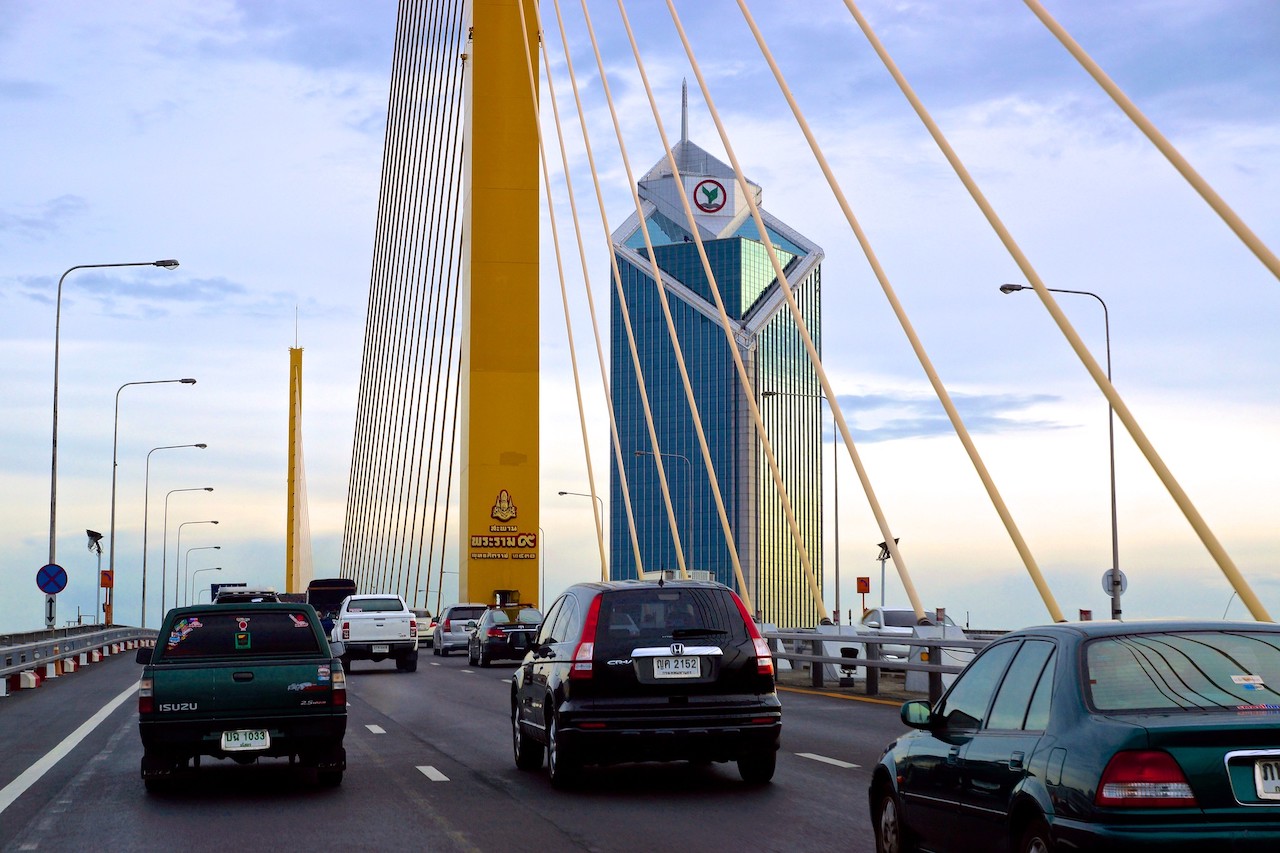 The Rama IX bridge over the Chao Phraya river with the Kasikorn Bank building in Bangkok.