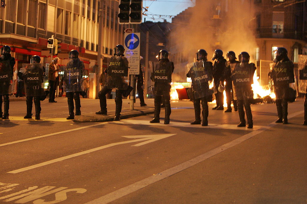 Policemen in riot control gear operating in Lausanne