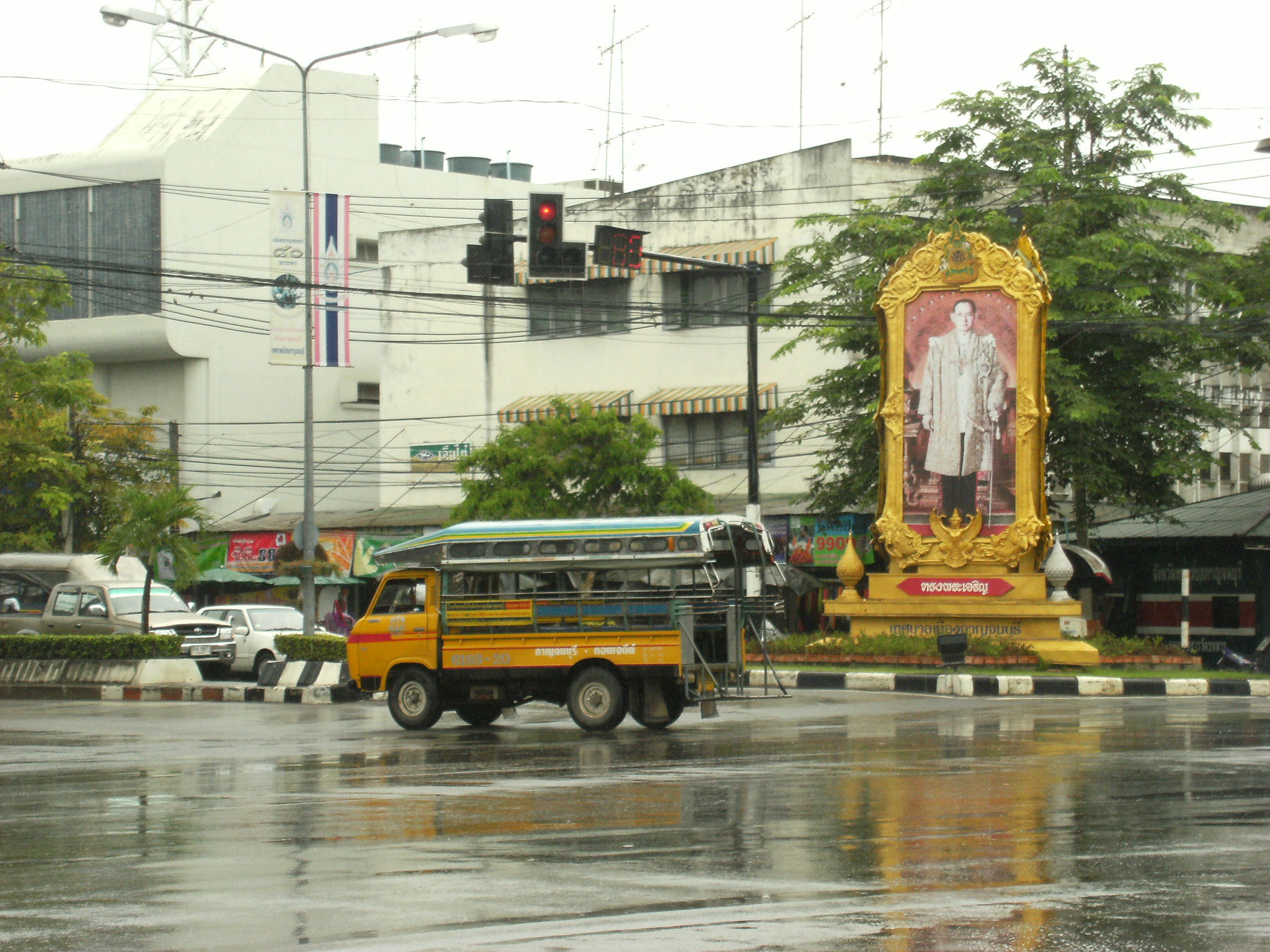 Portrait of King Bhumibol Adulyadej and a songthaew (baht bus) in Kanchanaburi