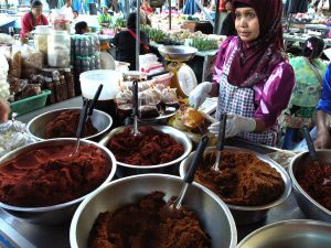 Malay-Muslim woman from Southern Thailand selling food at the market