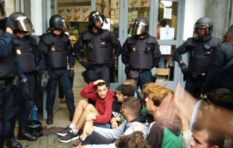 Spanish police officers charge against peaceful voters in Catalonia