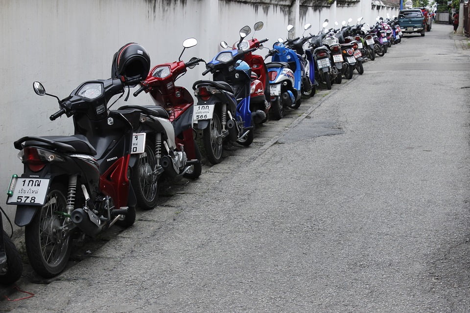 Parked motorcycles on a street in Thailand