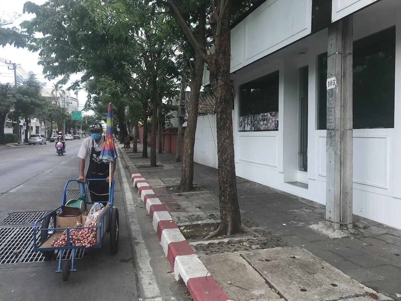 Street vendor with no customers in the empty street in Bangkok during COVID-19 pandemic