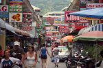 Tourists walking along a street in Patong Beach in Phuket.