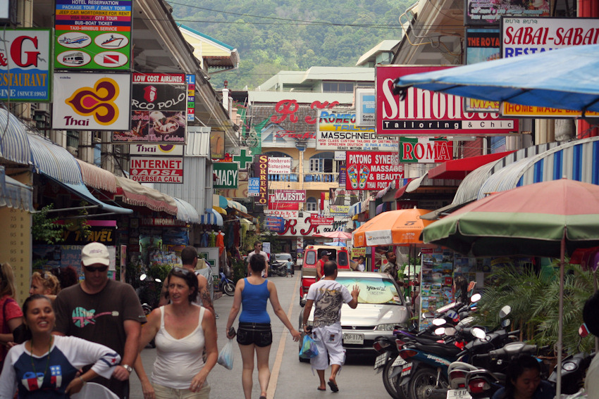 Tourists walking along a street in Patong Beach in Phuket.