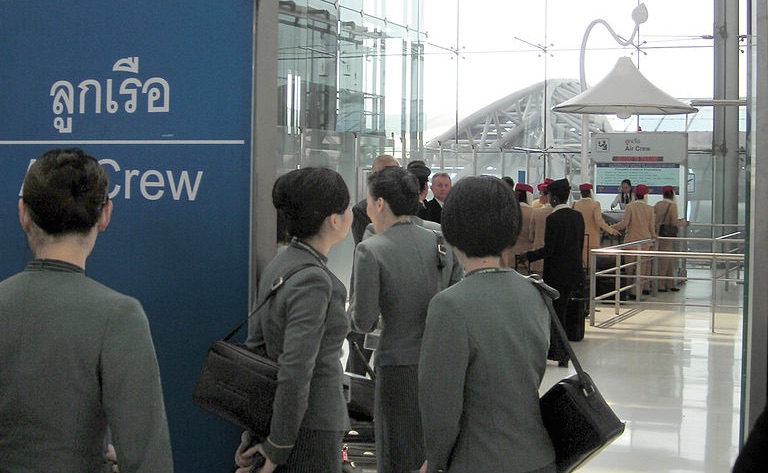 EVA Air flight attendants at a crew counter of the Immigration Bureau at Suvarnabhumi Airport, Bangkok