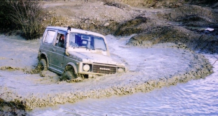 Suzuki Samurai SJ 1 crossing a a river in Thailand.