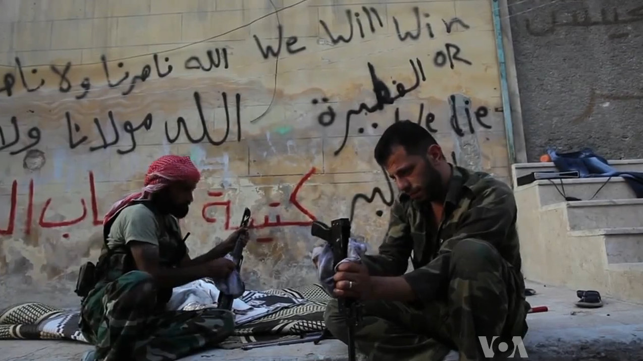 Free Syrian Army soldiers cleaning their AK-47s during the Battle of Aleppo