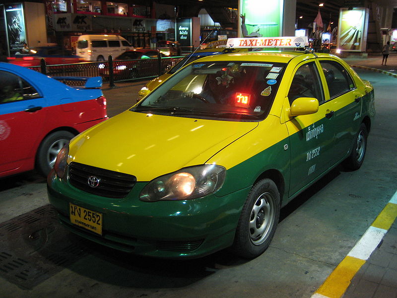 Toyota Corolla Altis yellow taxi in Bangkok