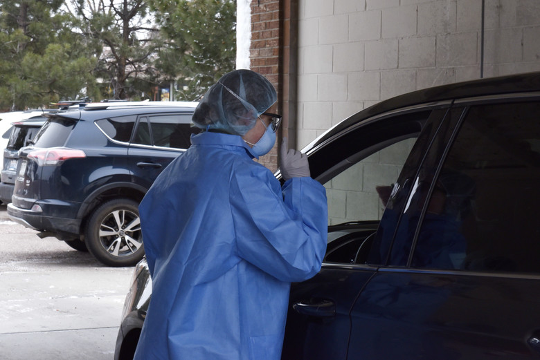 A 21st Medical Group professional tests an individual for the Coronavirus at Peterson Air Force Base, Colorado, March 20, 2020. In order to be tested for COVID-19, patients must first be evaluated by phone and meet criteria recommended by the Centers for Disease Control. Medical staff will test patients who will remain in their vehicle. (Air Force photo by Airman 1st Class Alexis Christian) PHOTO DETAILS / DOWNLOAD HI-RES 2 of 4 A 21st Medical Group professional tests an individual for the Coronavirus at Peterson Air Force Base, Colorado, USA, March 20, 2020