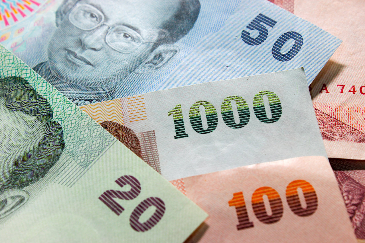 A pile of 20, 50, 100 and 1000 Thai baht notes