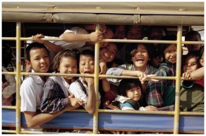 A songthaew (baht bus) loaded with students on the way home from school in Kantharalak