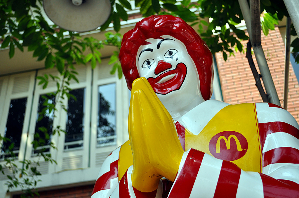 Thai Ronald McDonald greeting customers at McDonalds restaurant