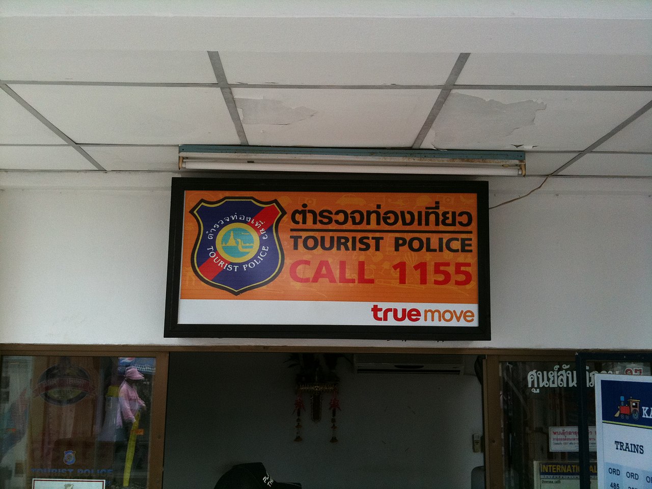Sign with the caption 'Thai Tourist police call 155'